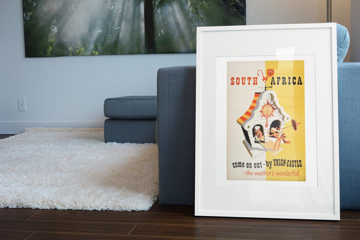 South Africa Union Castle poster leaning beside a blue sofa