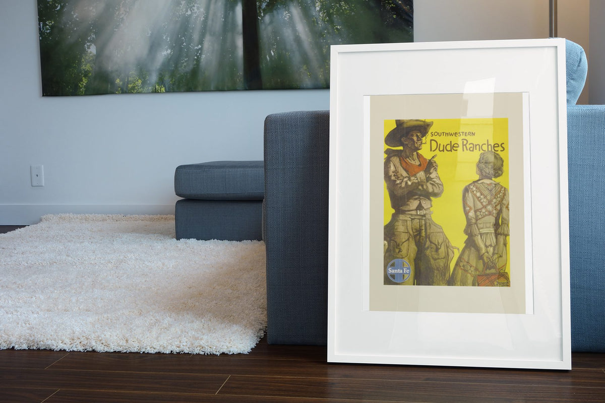 Southwestern Dude Ranches Santa Fe poster leaning beside a blue sofa