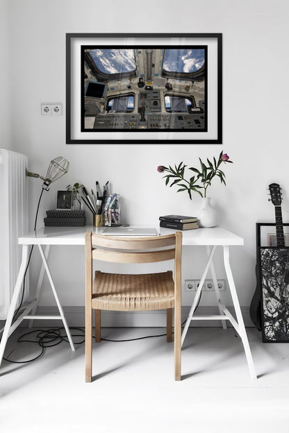 Space Shuttle Atlantis cockpit poster framed in a bright home office