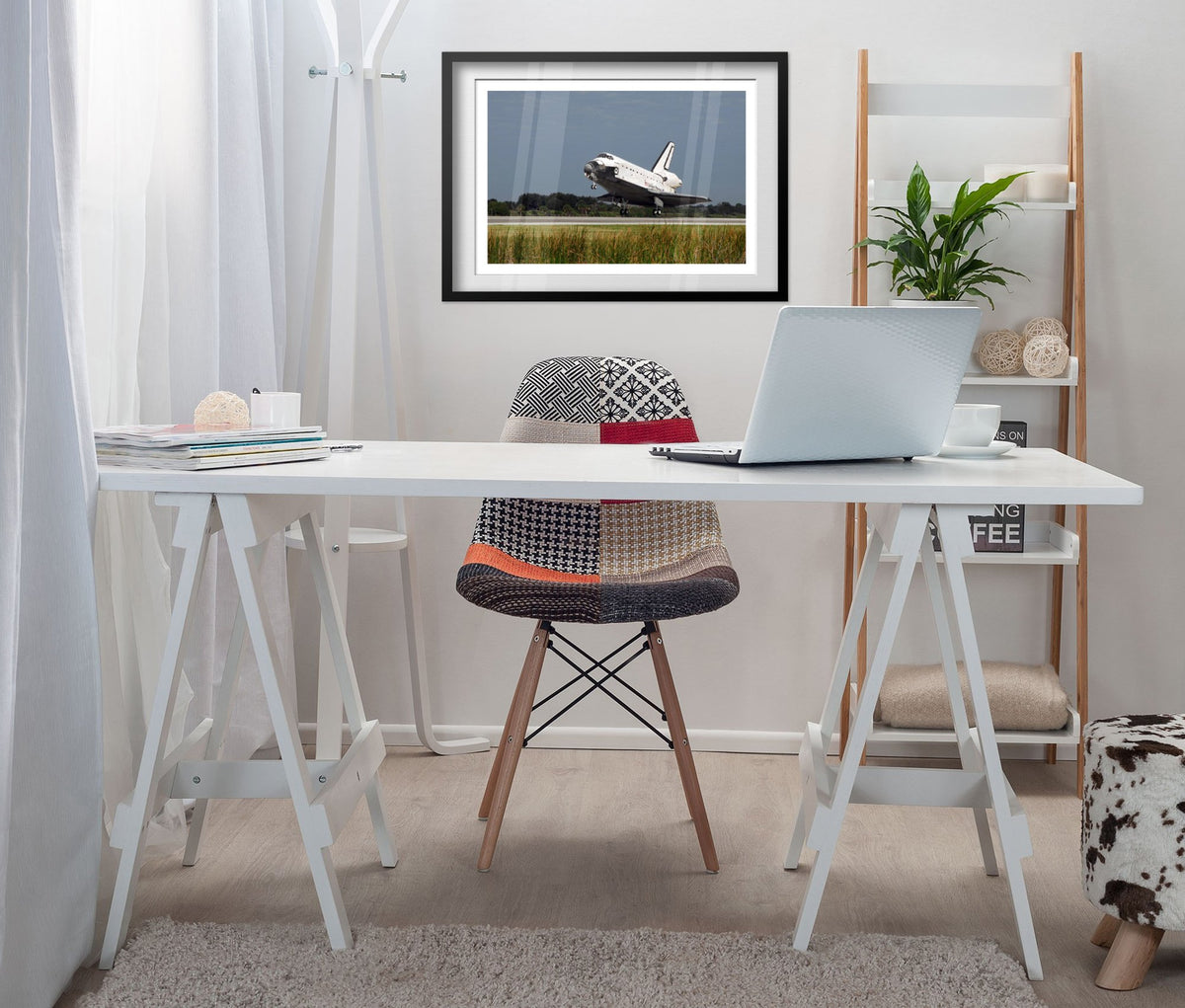 Space Shuttle Atlantis landing poster framed above a white desk