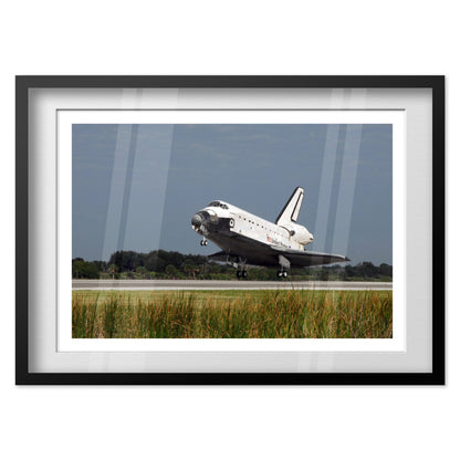 Space Shuttle Atlantis landing poster in a black frame