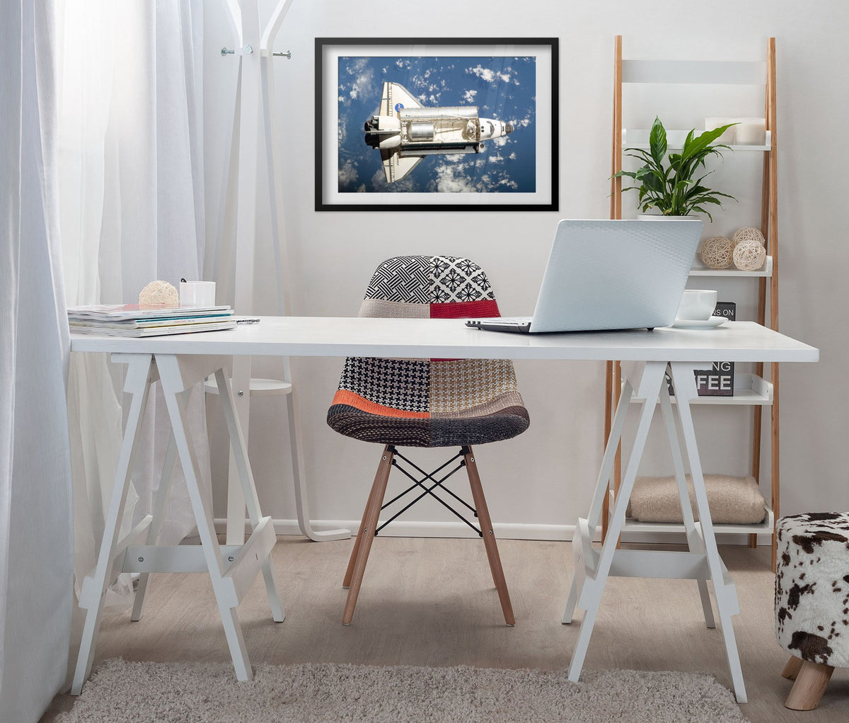 Space Shuttle Endeavour in orbit poster framed above a white desk