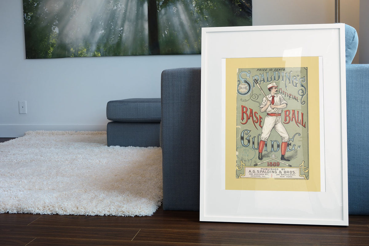 Spalding Base Ball Guide 1889 poster leaning beside a blue sofa