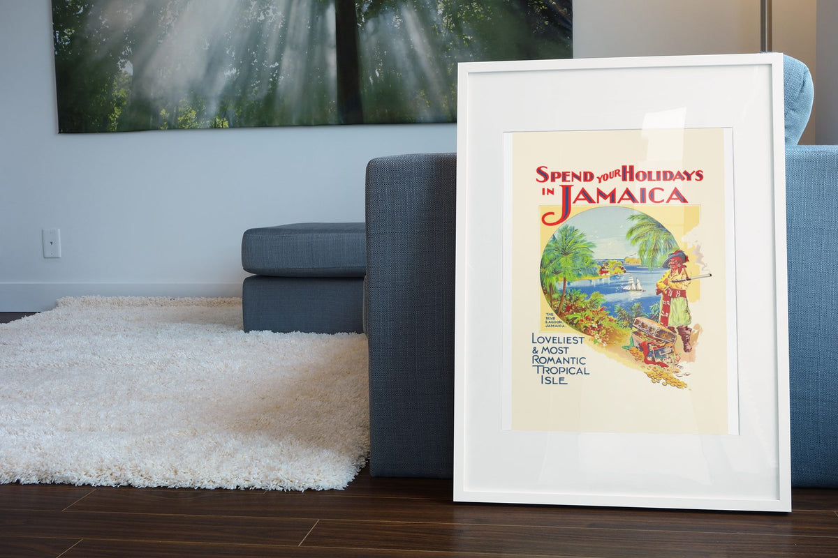 Spend Your Holidays in Jamaica poster leaning beside a blue sofa