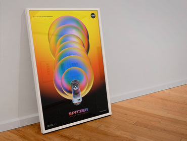 Spitzer Space Telescope poster in a white frame leaning against a wall