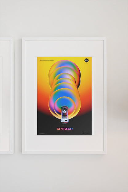 Spitzer Space Telescope poster in a white frame on a light wall