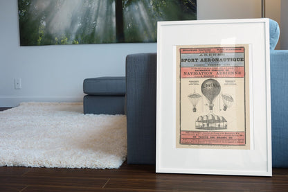 Sport Aeronautique Hot Air Balloon poster leaning beside a blue sofa