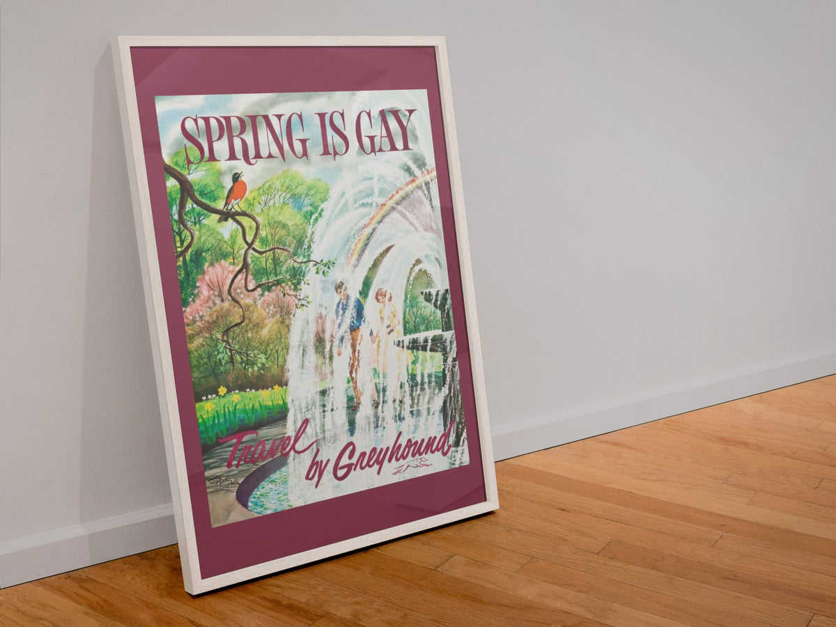 Spring is Gay Greyhound poster in a white frame leaning against a wall