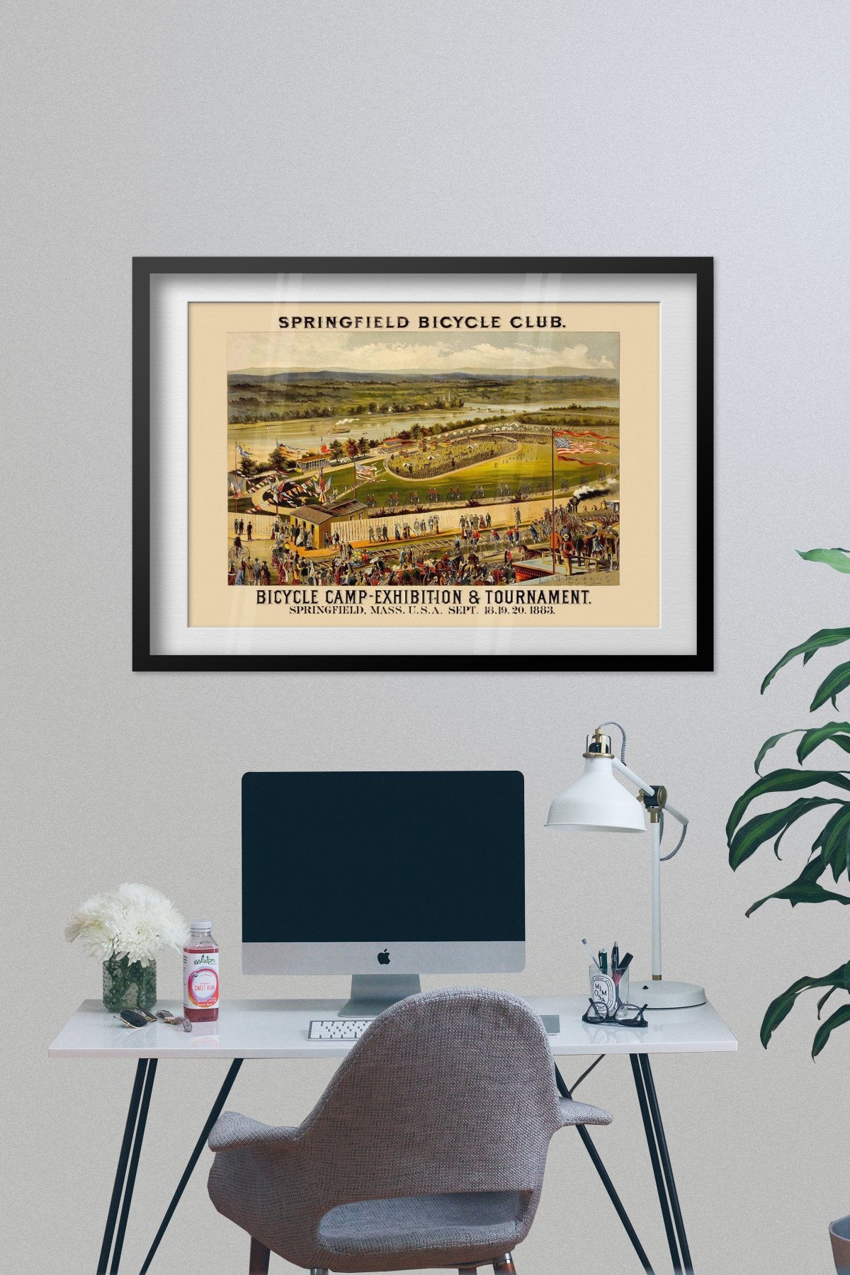 Springfield Bicycle Club 1883 poster framed on a grey wall above a desk