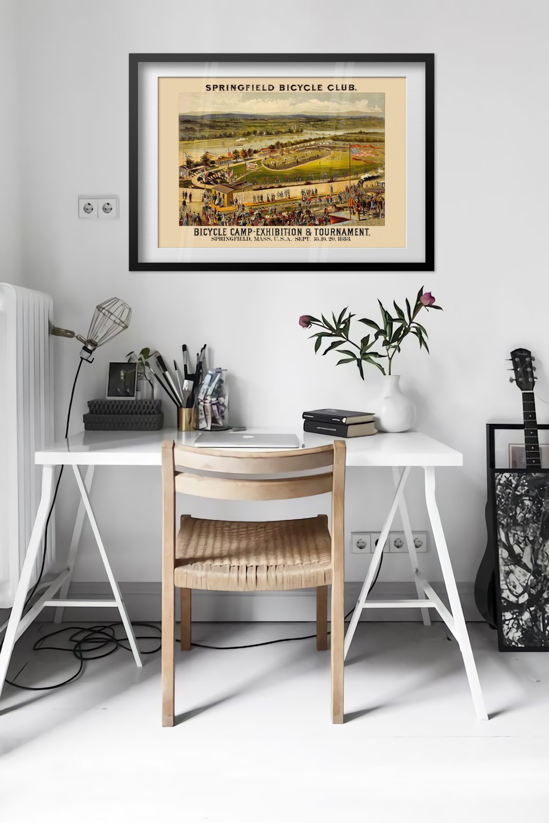 Springfield Bicycle Club 1883 poster framed above a desk in a bright white room