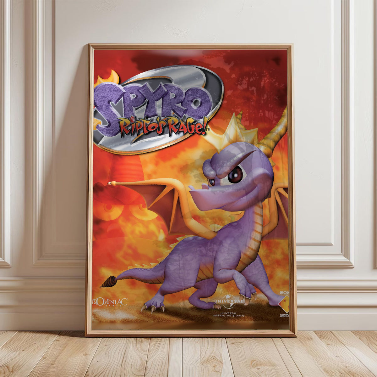 Spyro 2: Ripto's Rage! Box Art poster in a light oak frame leaning against a white wall