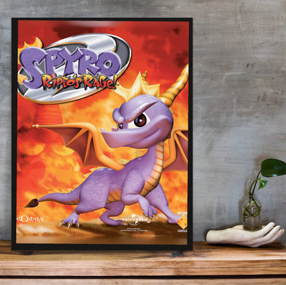 Spyro 2: Ripto's Rage! Box Art poster in a black frame on a wooden shelf against concrete