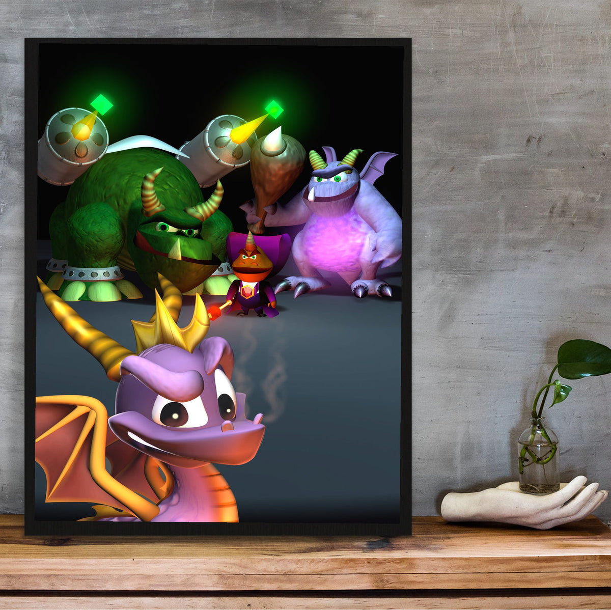 Spyro 2: Ripto's Rage! New Bosses Key Art poster in a black frame on a wooden shelf against concrete