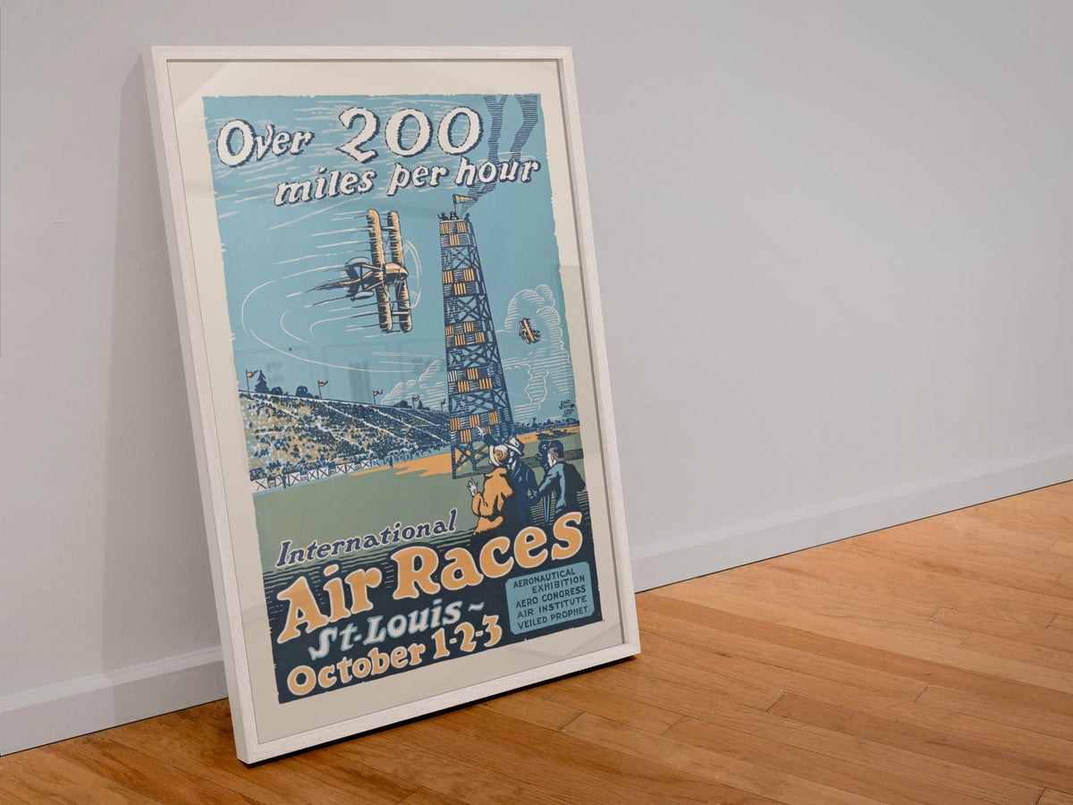 St Louis International Air Races poster in a white frame leaning against a wall