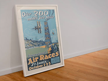 St Louis International Air Races poster in a white frame leaning against a wall