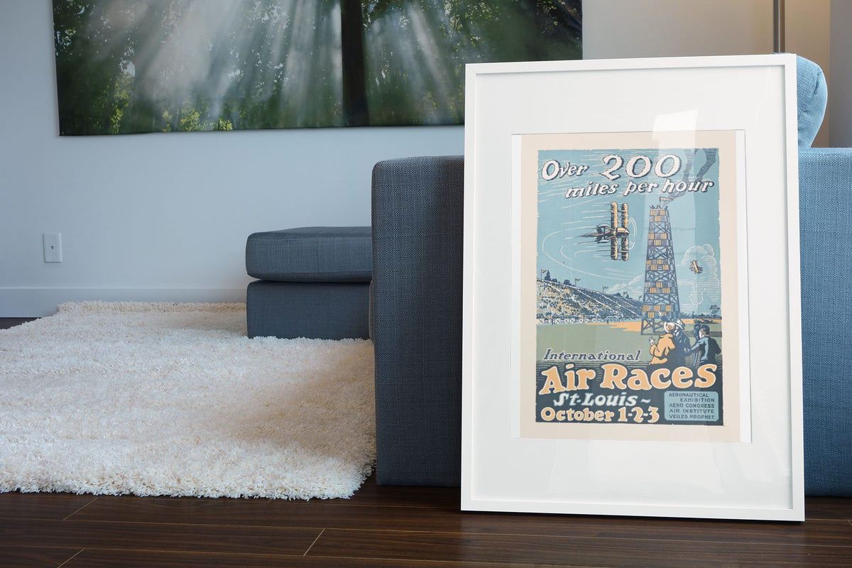 St Louis International Air Races poster leaning beside a blue sofa
