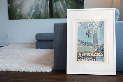 St Louis International Air Races poster leaning beside a blue sofa