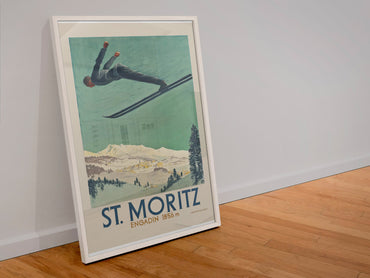 St. Moritz Engadin poster in a white frame leaning against a wall
