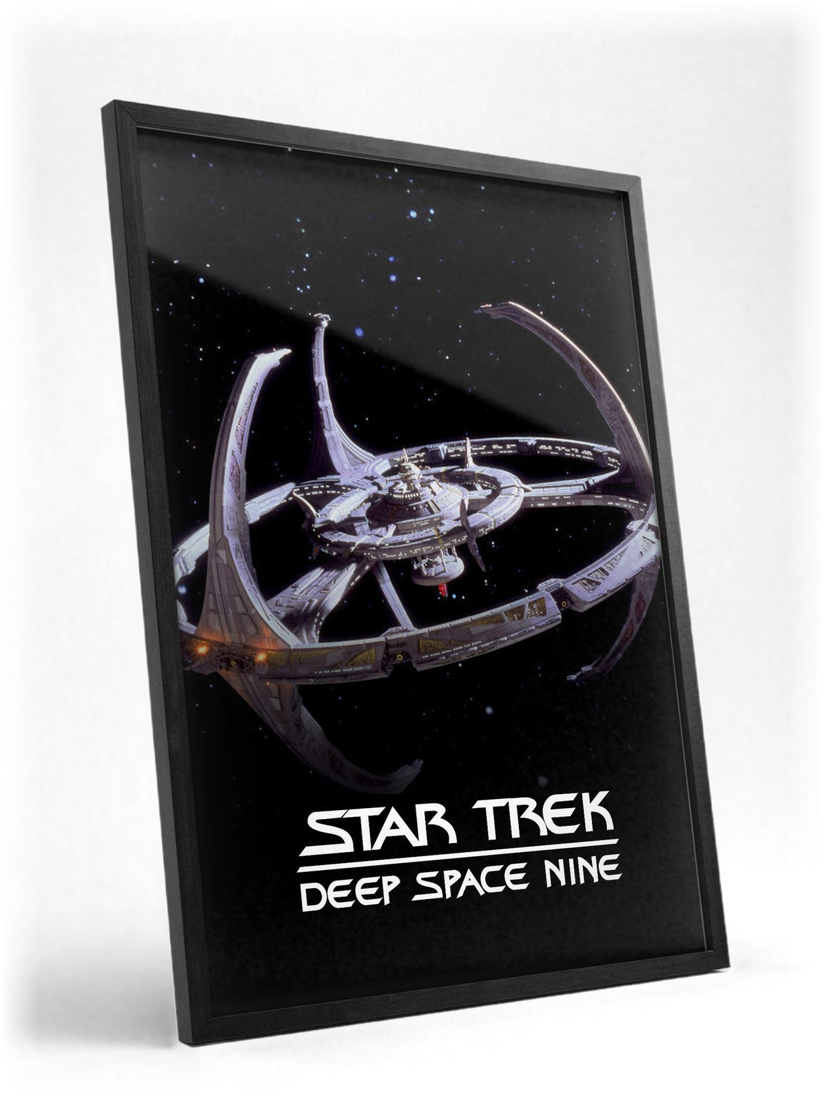 Star Trek: Deep Space Nine poster in a black frame with glass leaning against a wall