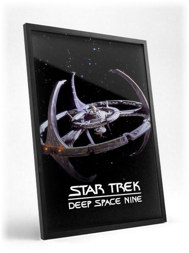 Star Trek: Deep Space Nine poster in a black frame with glass leaning against a wall