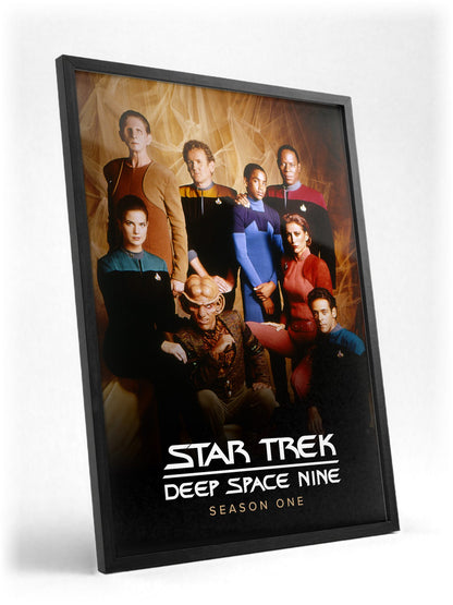Star Trek: Deep Space Nine poster in a black frame with glass leaning against a wall