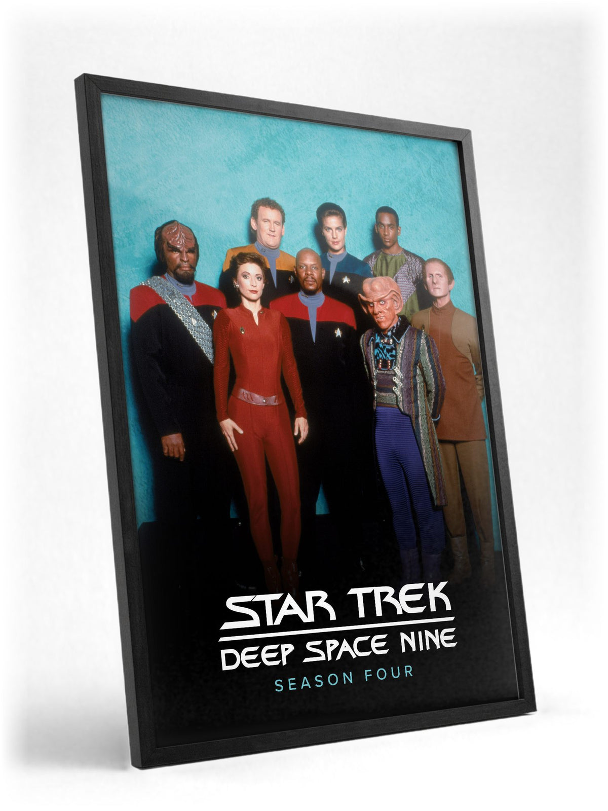 Star Trek: Deep Space Nine poster in a black frame with glass leaning against a wall