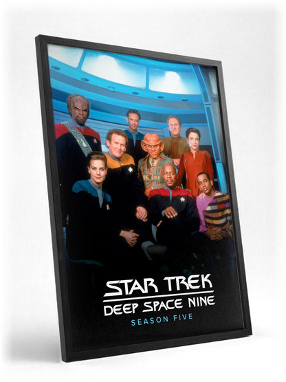Star Trek: Deep Space Nine poster in a black frame with glass leaning against a wall