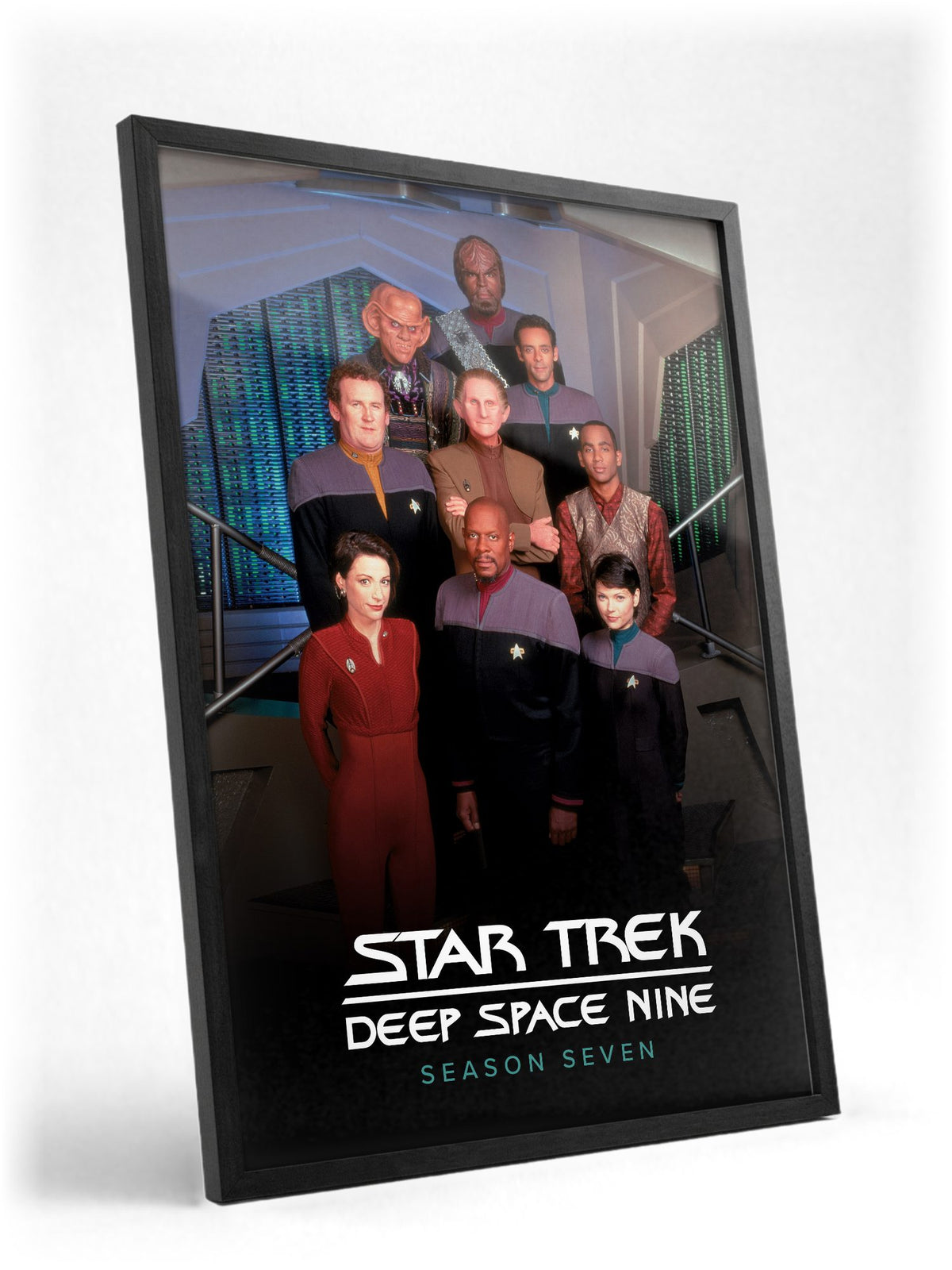 Star Trek: Deep Space Nine poster in a black frame with glass leaning against a wall