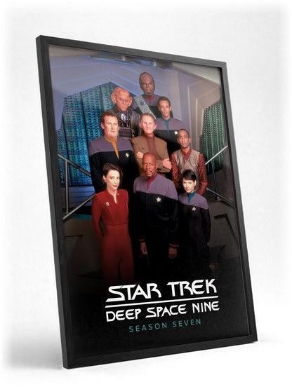 Star Trek: Deep Space Nine poster in a black frame with glass leaning against a wall