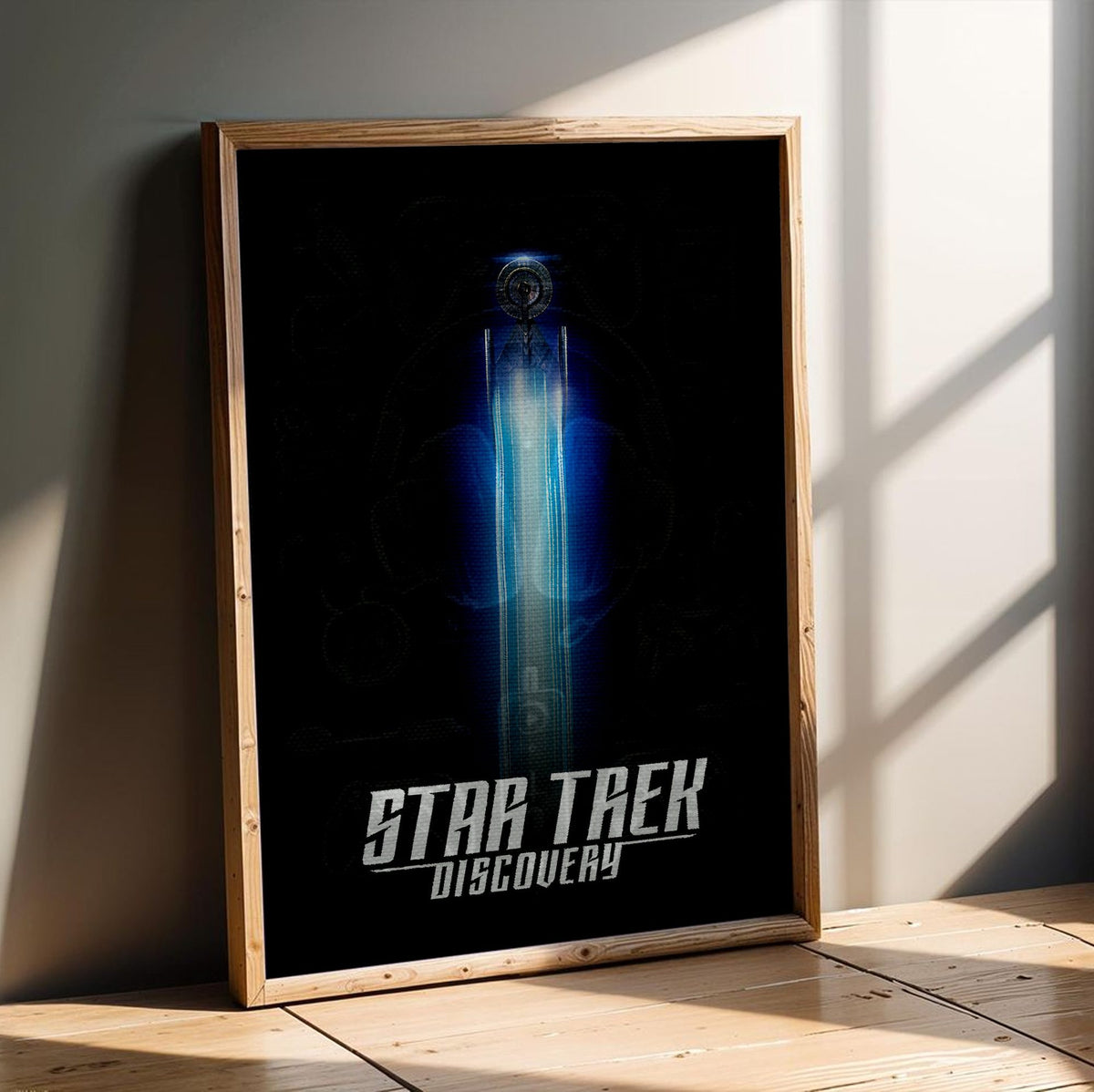 Star Trek: Discovery poster in an oak frame leaning on a wooden floor