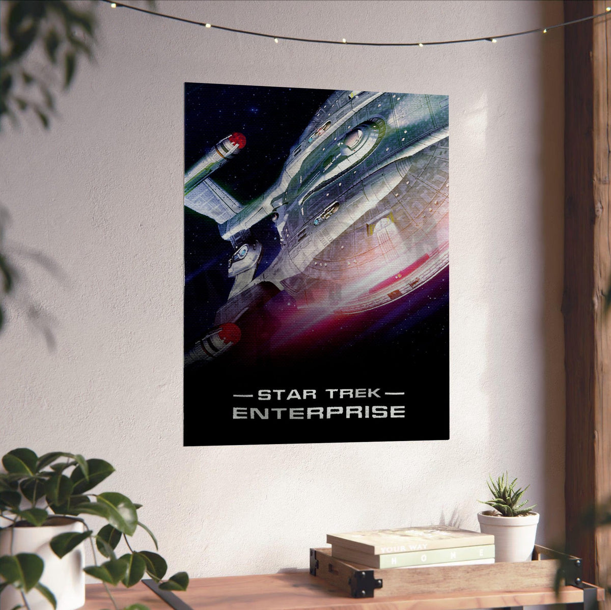 Star Trek: Enterprise poster unframed on a white wall above a desk
