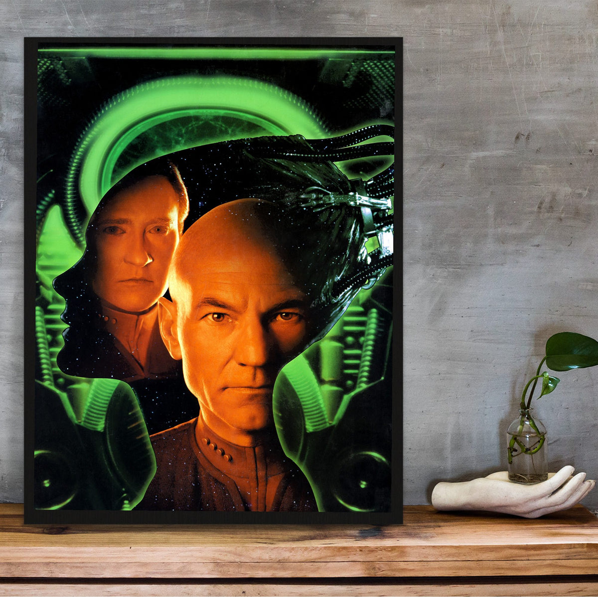 Star Trek: First Contact (1996) Movie Key Art poster in a black frame on a wooden shelf against concrete