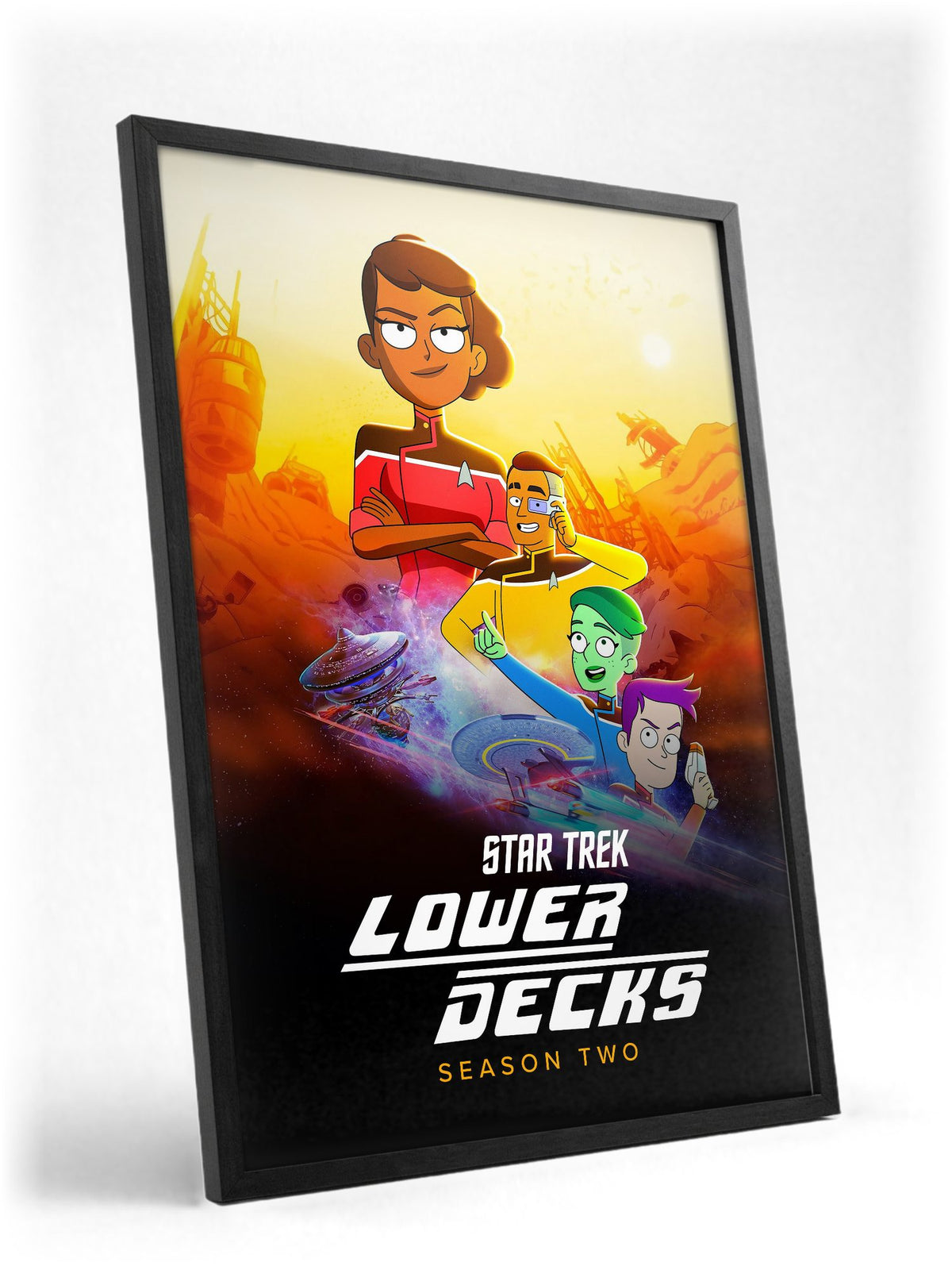 Star Trek: Lower Decks poster in a black frame with glass leaning against a wall