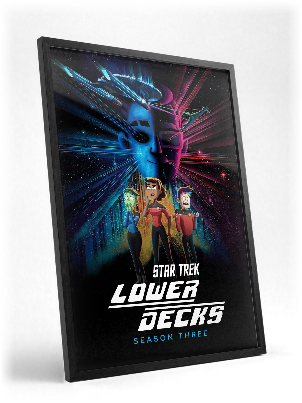 Star Trek: Lower Decks poster in a black frame with glass leaning against a wall