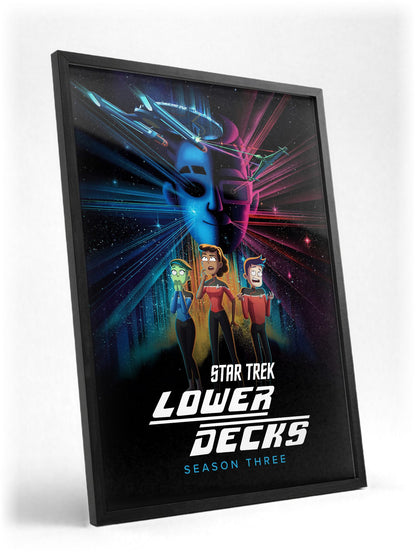 Star Trek: Lower Decks poster in a black frame with glass leaning against a wall
