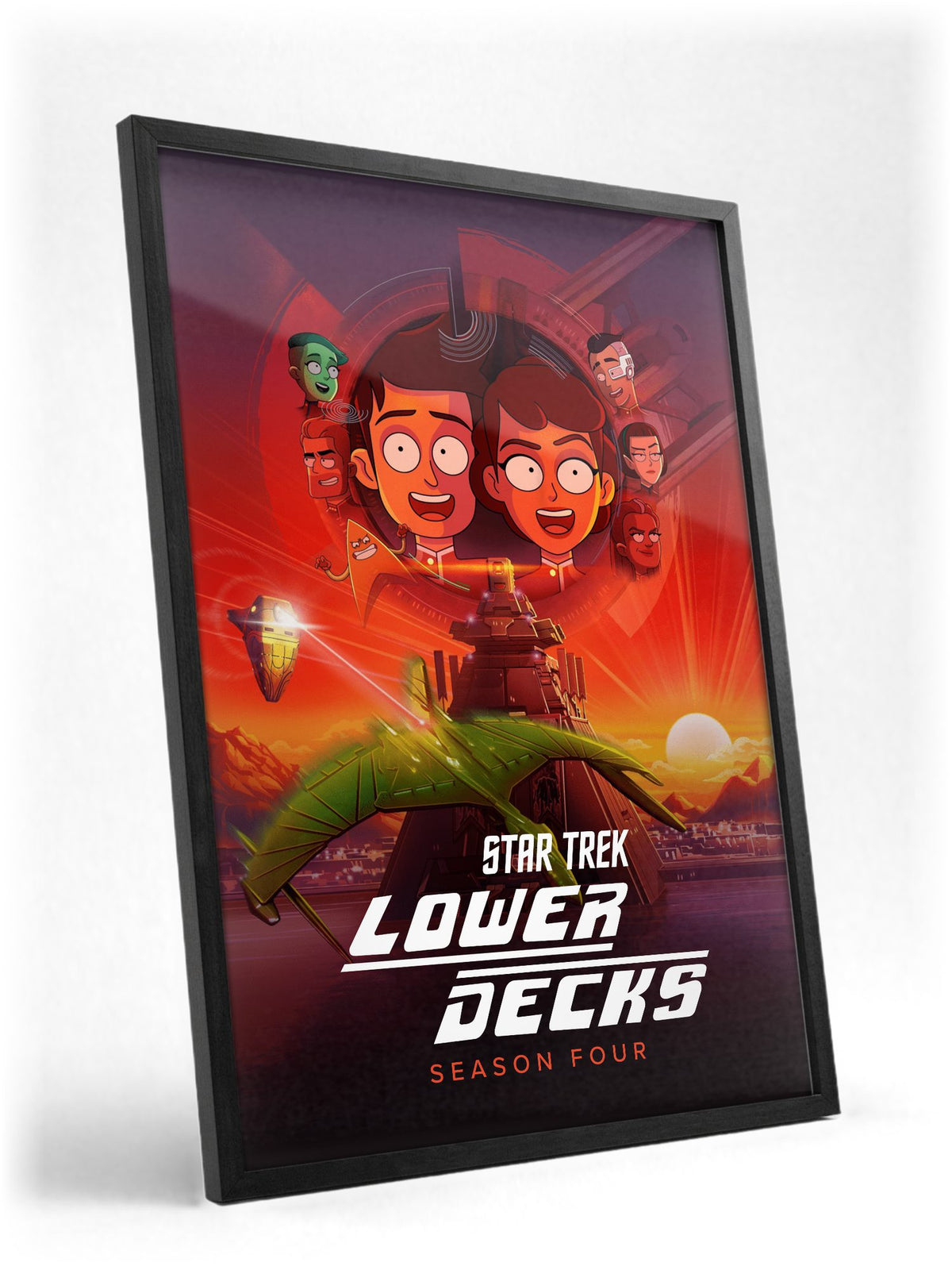 Star Trek: Lower Decks poster in a black frame with glass leaning against a wall