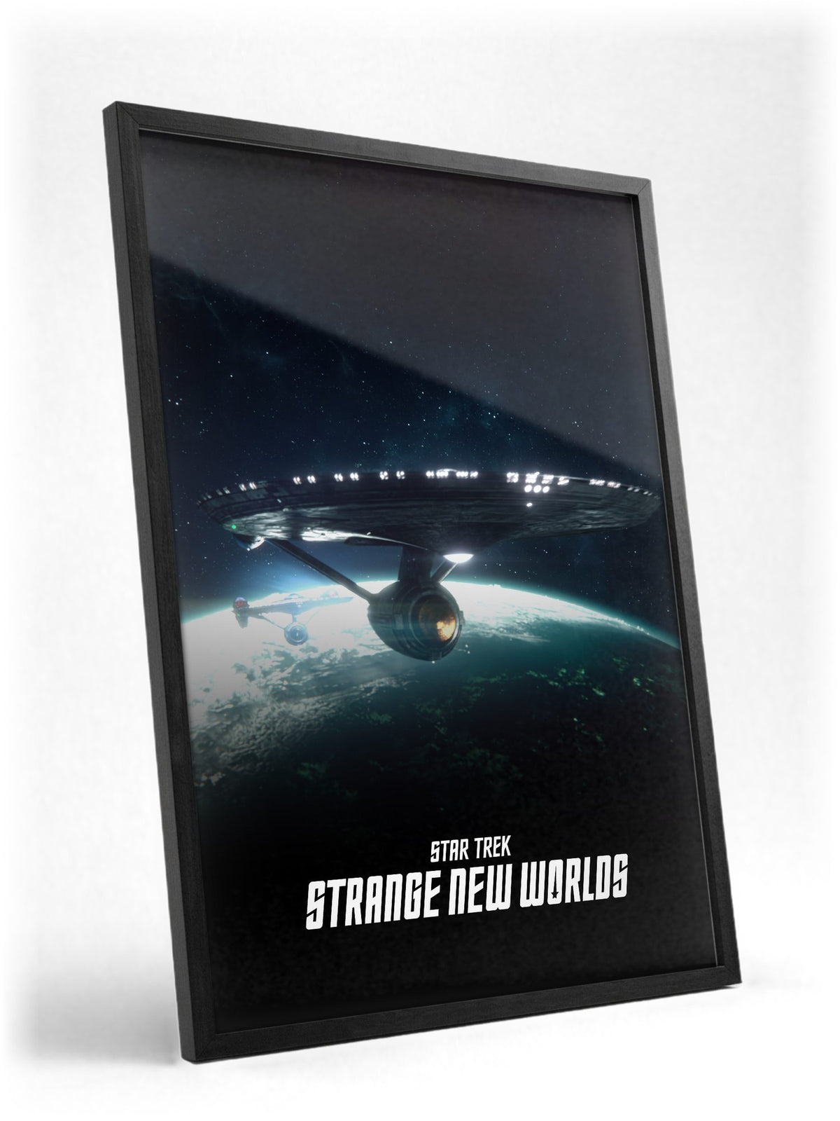 Star Trek: Strange New Worlds poster in a black frame with glass leaning against a wall