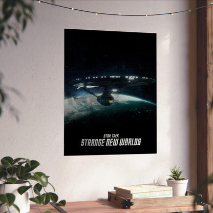 Star Trek: Strange New Worlds poster unframed on a white wall above a desk