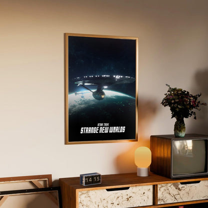 Star Trek: Strange New Worlds poster in an oak frame above a sideboard