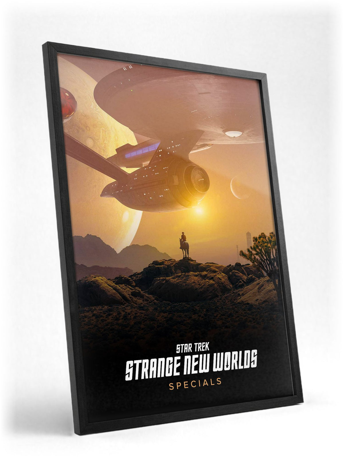 Star Trek: Strange New Worlds poster in a black frame with glass leaning against a wall
