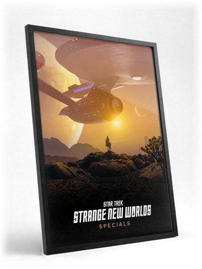 Star Trek: Strange New Worlds poster in a black frame with glass leaning against a wall