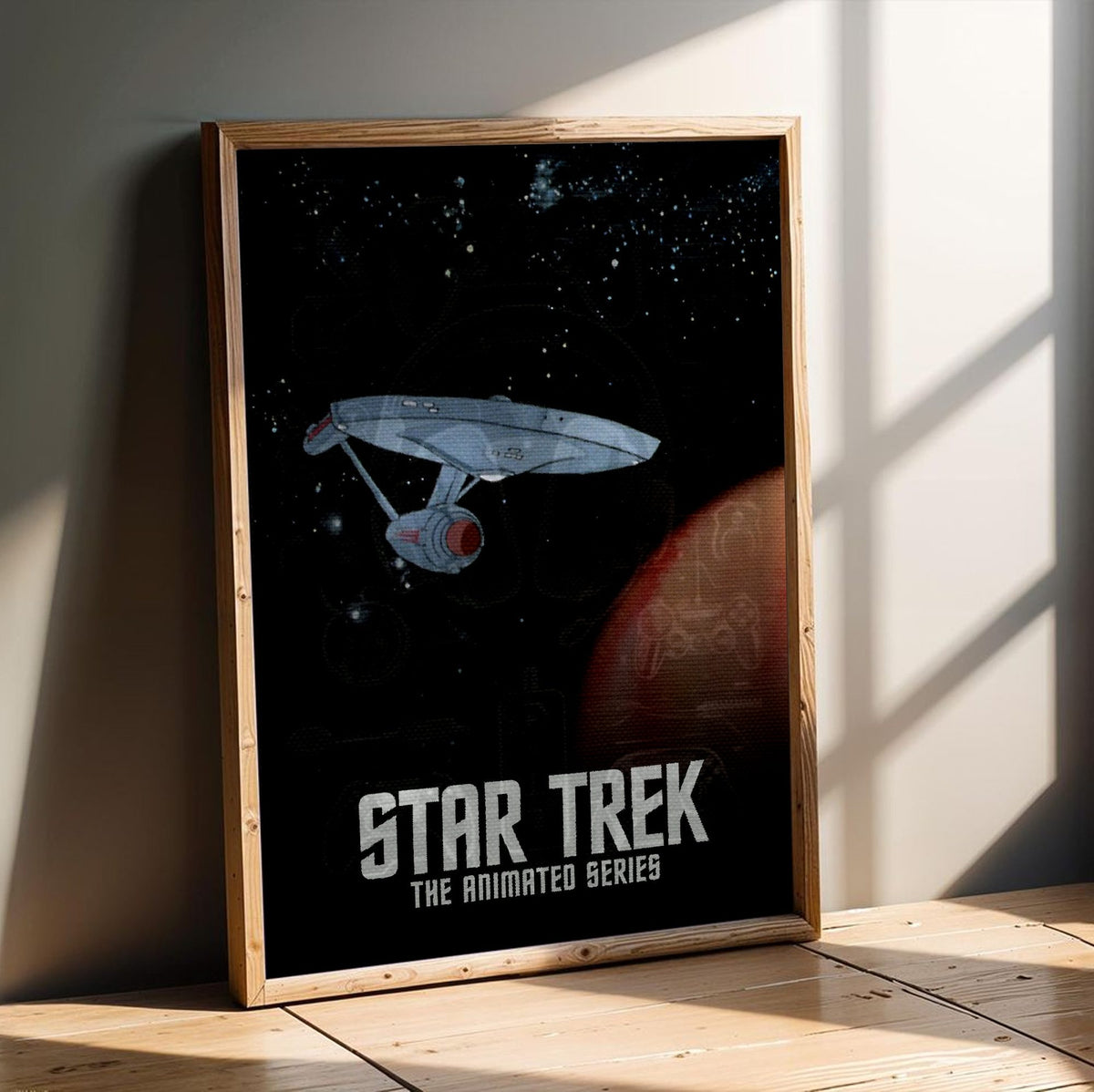 Star Trek: The Animated Series poster in an oak frame leaning on a wooden floor