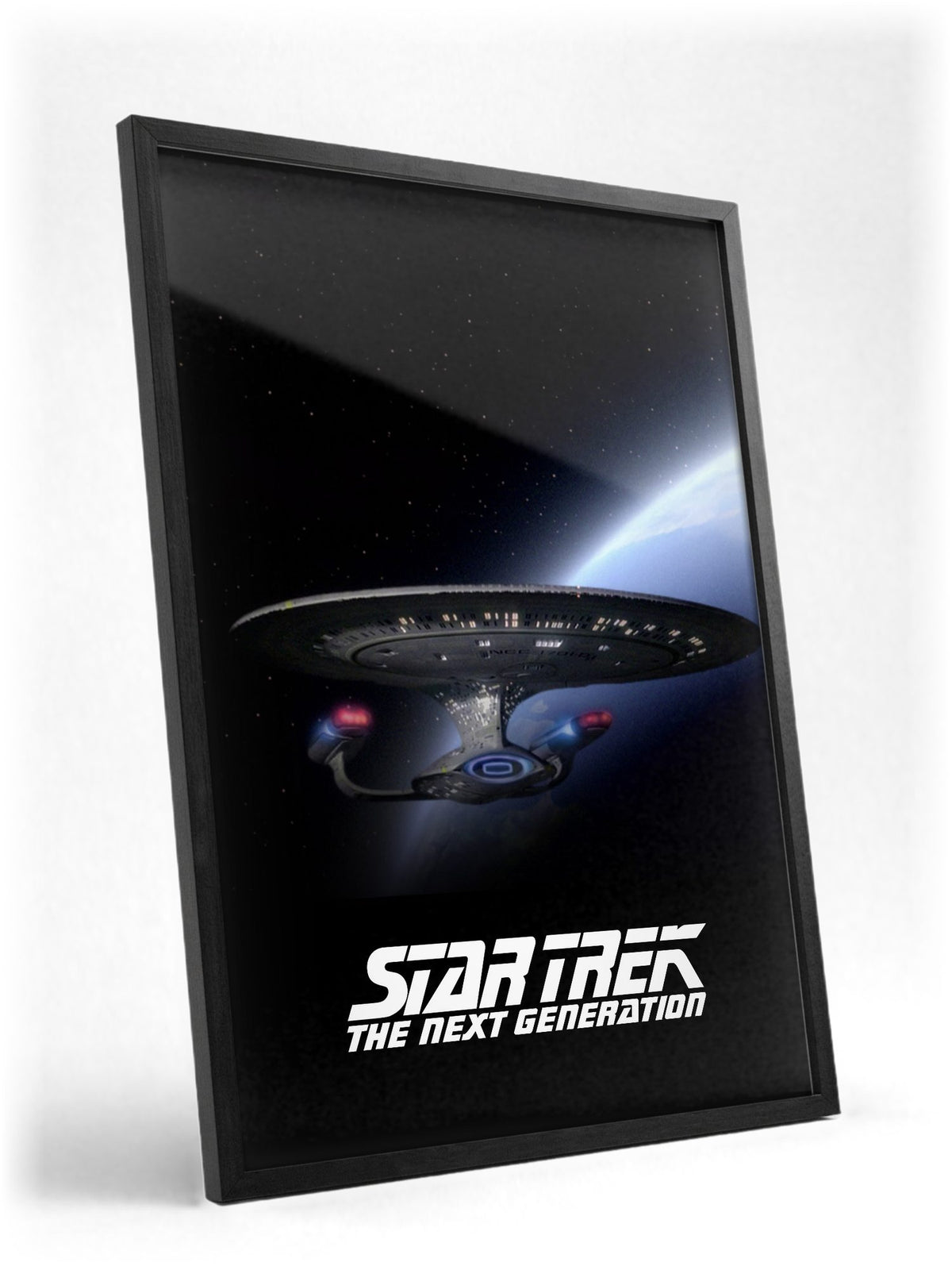 Star Trek: The Next Generation poster in a black frame with glass leaning against a wall