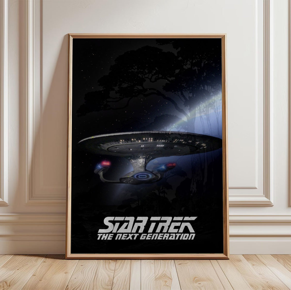 Star Trek: The Next Generation poster in a light oak frame leaning against a white wall