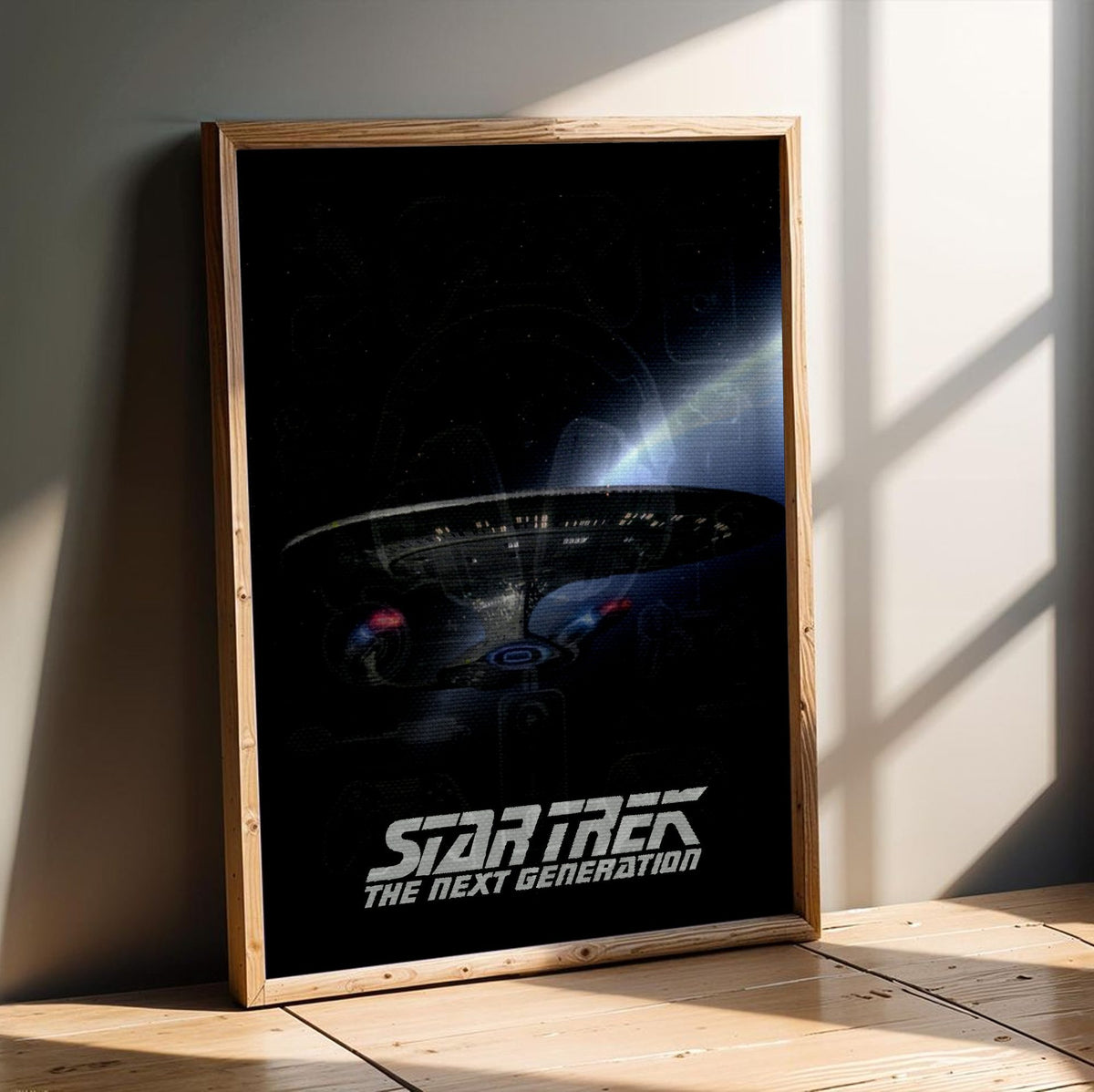 Star Trek: The Next Generation poster in an oak frame leaning on a wooden floor