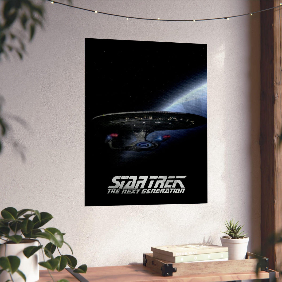 Star Trek: The Next Generation poster unframed on a white wall above a desk