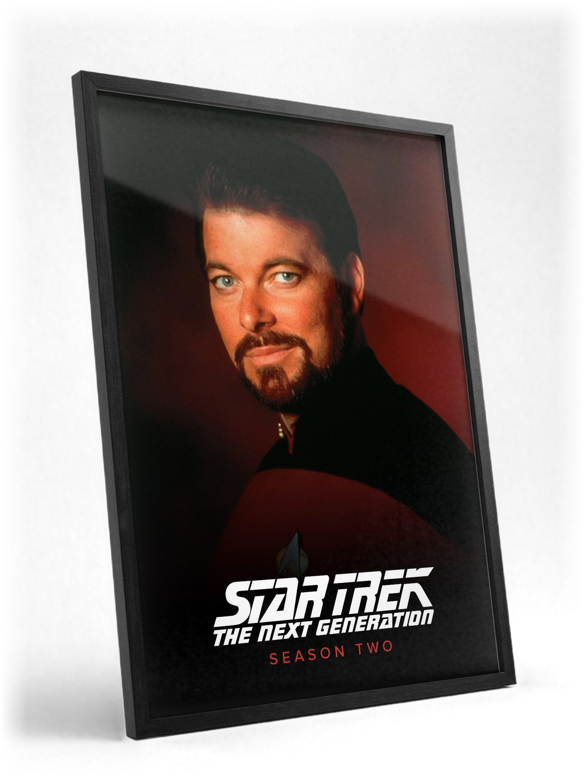 Star Trek: The Next Generation poster in a black frame with glass leaning against a wall