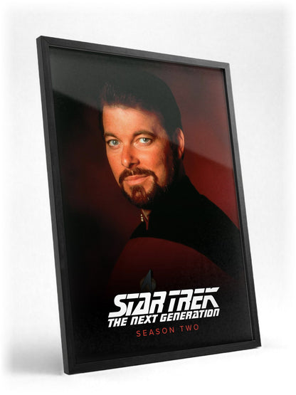 Star Trek: The Next Generation poster in a black frame with glass leaning against a wall