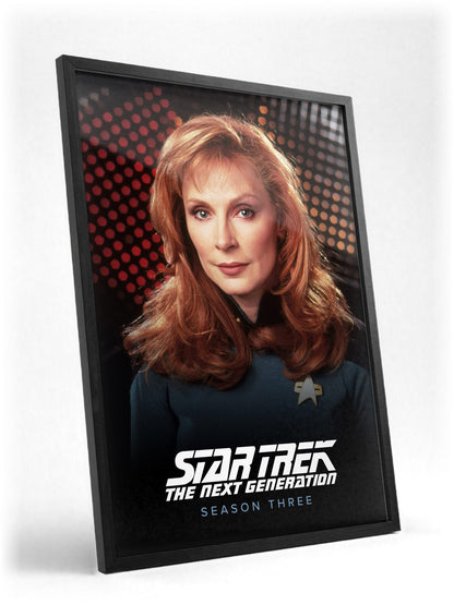 Star Trek: The Next Generation poster in a black frame with glass leaning against a wall