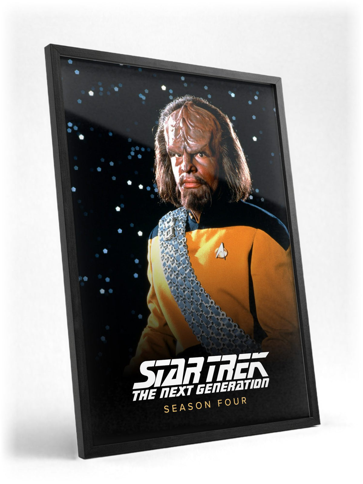 Star Trek: The Next Generation poster in a black frame with glass leaning against a wall